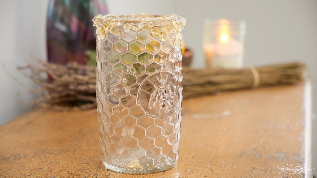 empty glass with honey lollipop rim on counter