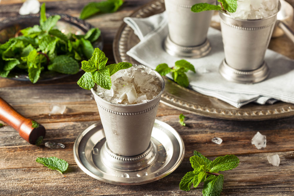 Mint Julep with Honey in silver cup on table