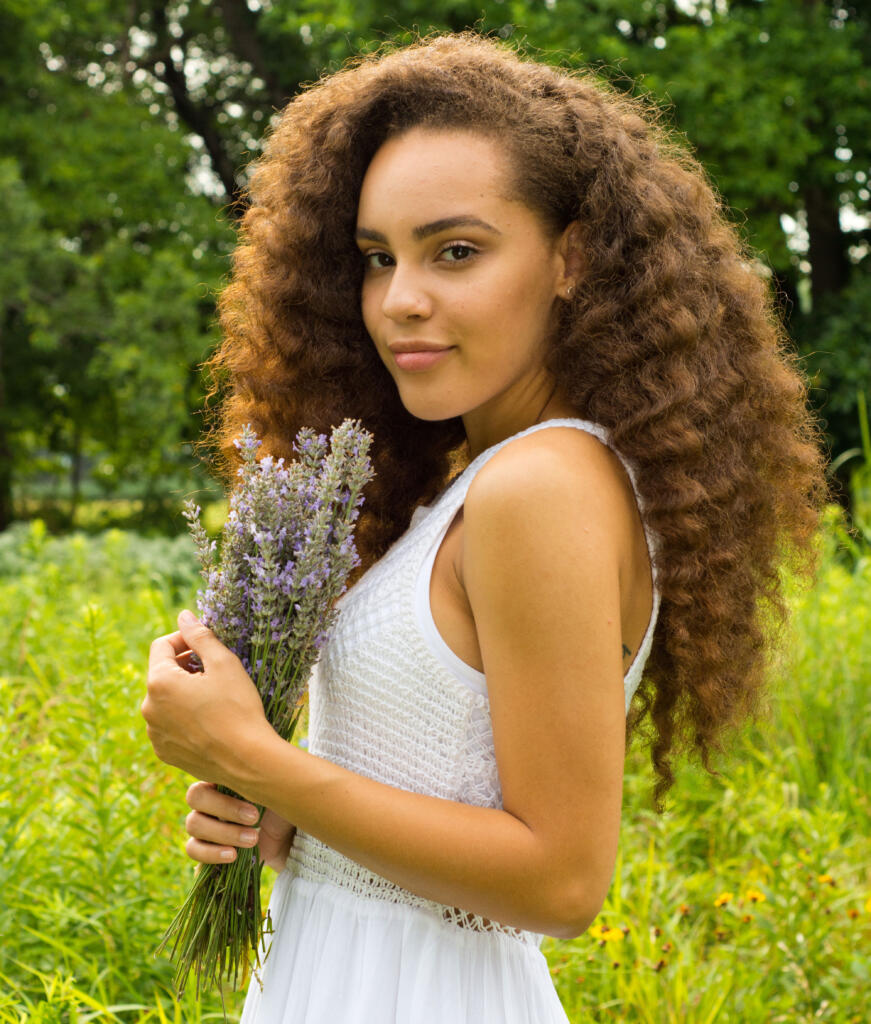 Morgan in field holding bouquet of fresh harvested lavender