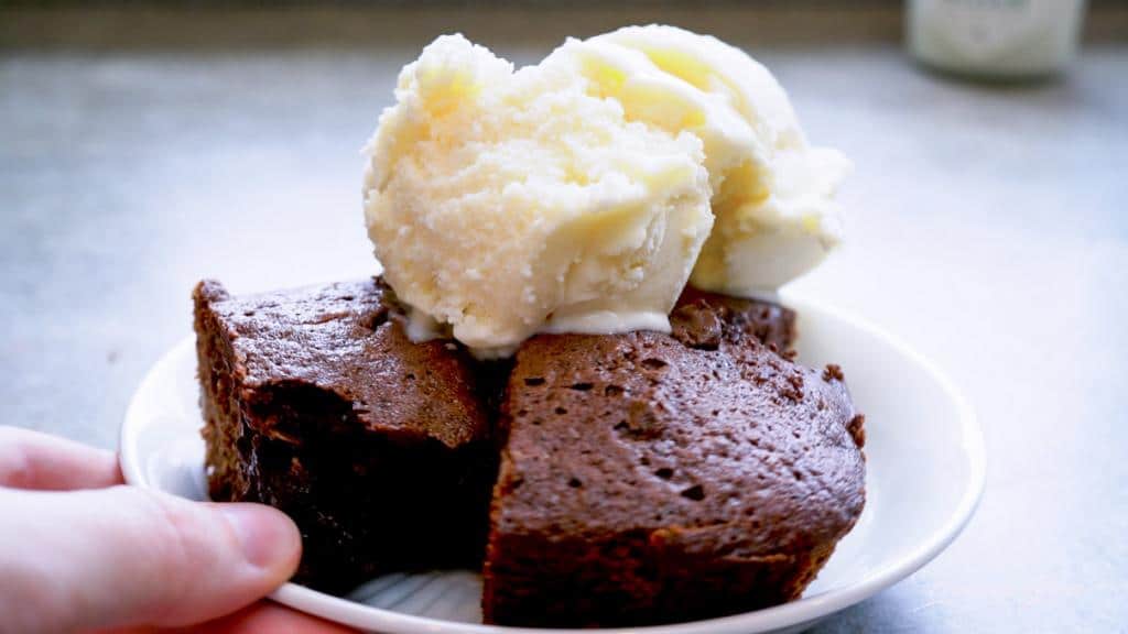 serving a plated brownie and ice cream sundae