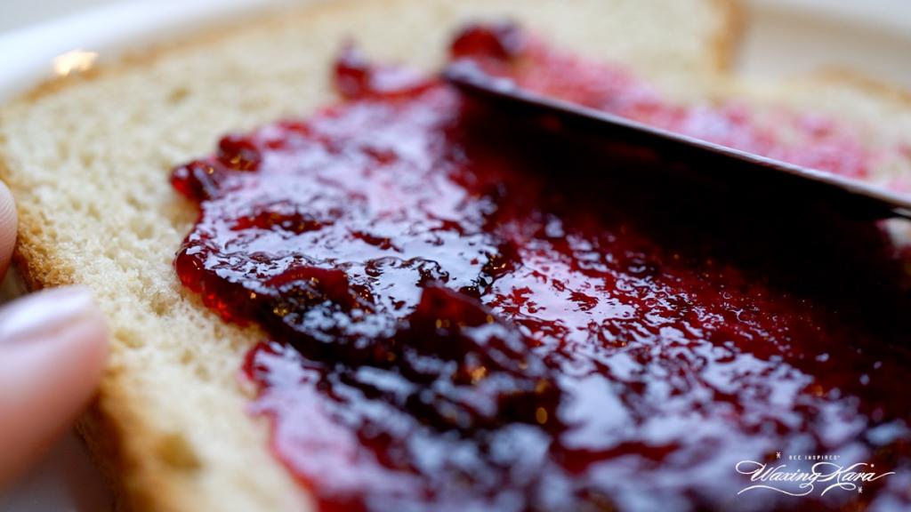 spreading jam on bread