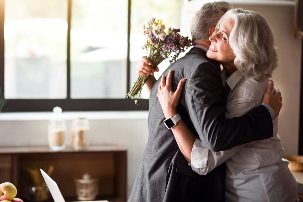 Parents of the Bride in receipt of wedding gifts for parents and embracing