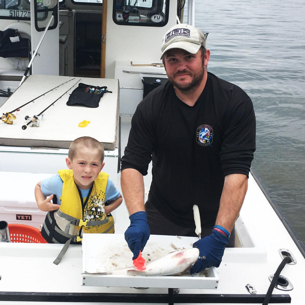 Our friends Willy and Billy in the back of their fishing boat after a fishing trip