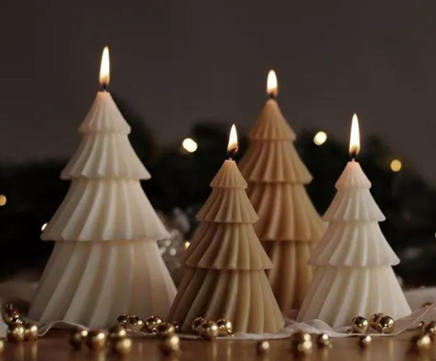 christmas tree shaped candles with twinkling lights and small sleigh bells