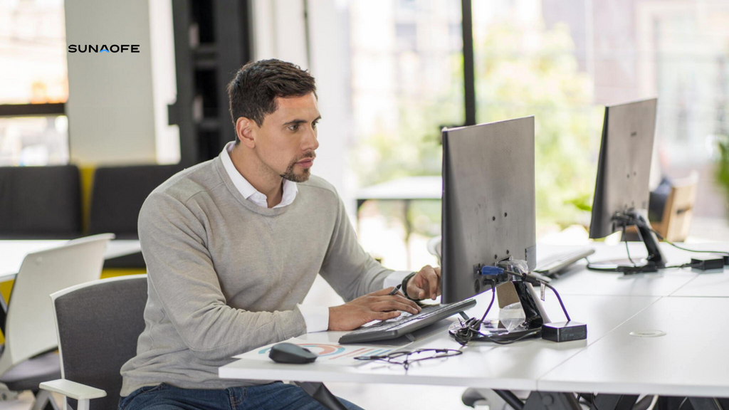 Average age 25-year-old Latino man dressed informally is in the office he works for using his laptop sunaofe blog 2240x1260