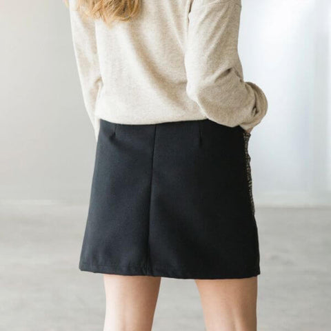 Black skirt combined with a beige sweater