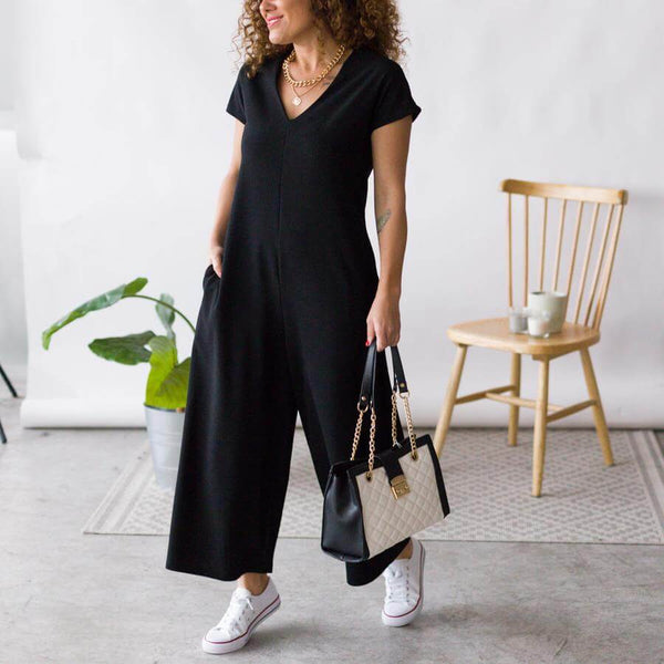 Black jumpsuit look with white accessories