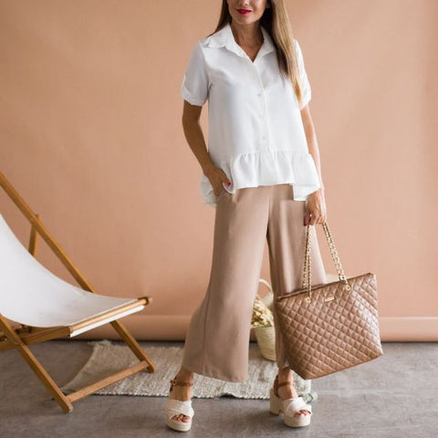 Beige pants combined with a white blouse