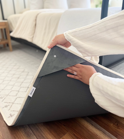 woman inserting tumble rug pad