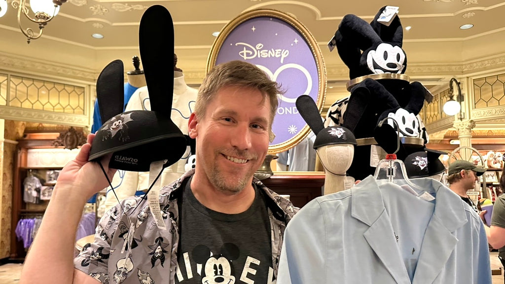 Mike holding Oswald merch at the Emporium