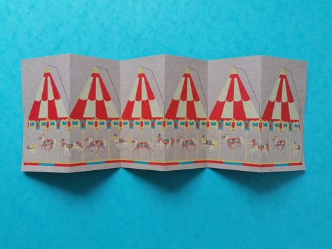 carousel card with tabs drawn on ready to cut, lay flat on a blue background