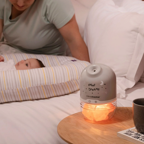 ClevaMama Salt Lamp and Humidifier with Baby next to Bed