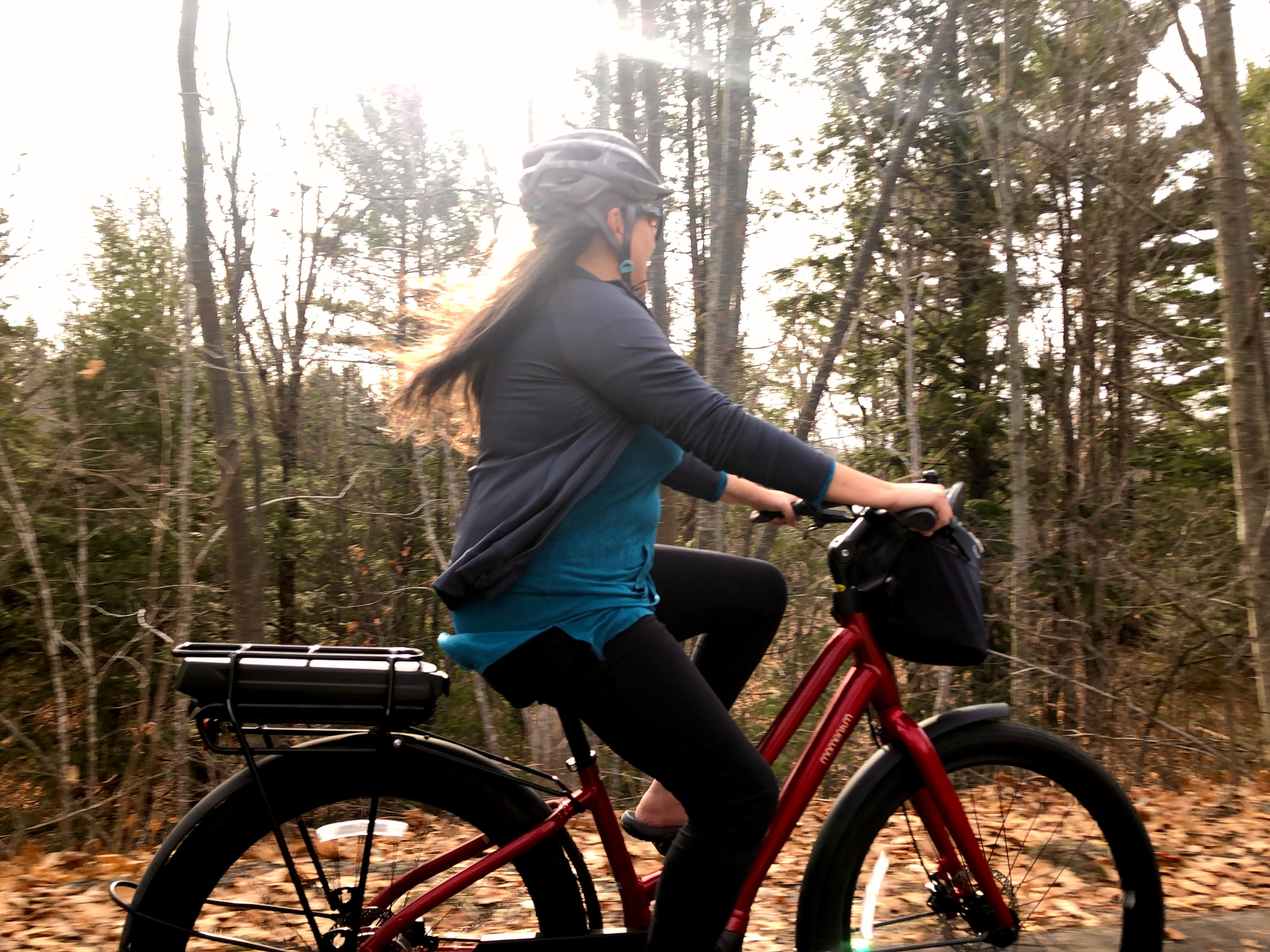 Riding an eBike down a leafy path through the forest