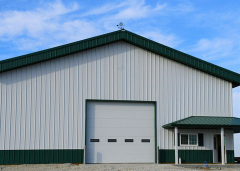 pole barn with green steel roof and white steel sides