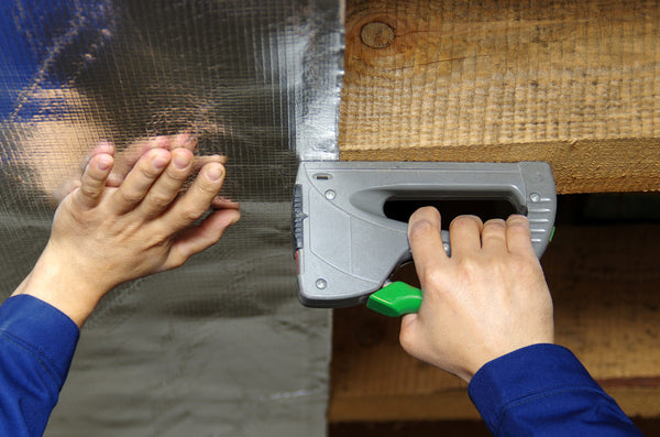 Installing radiant barrier to floor joists