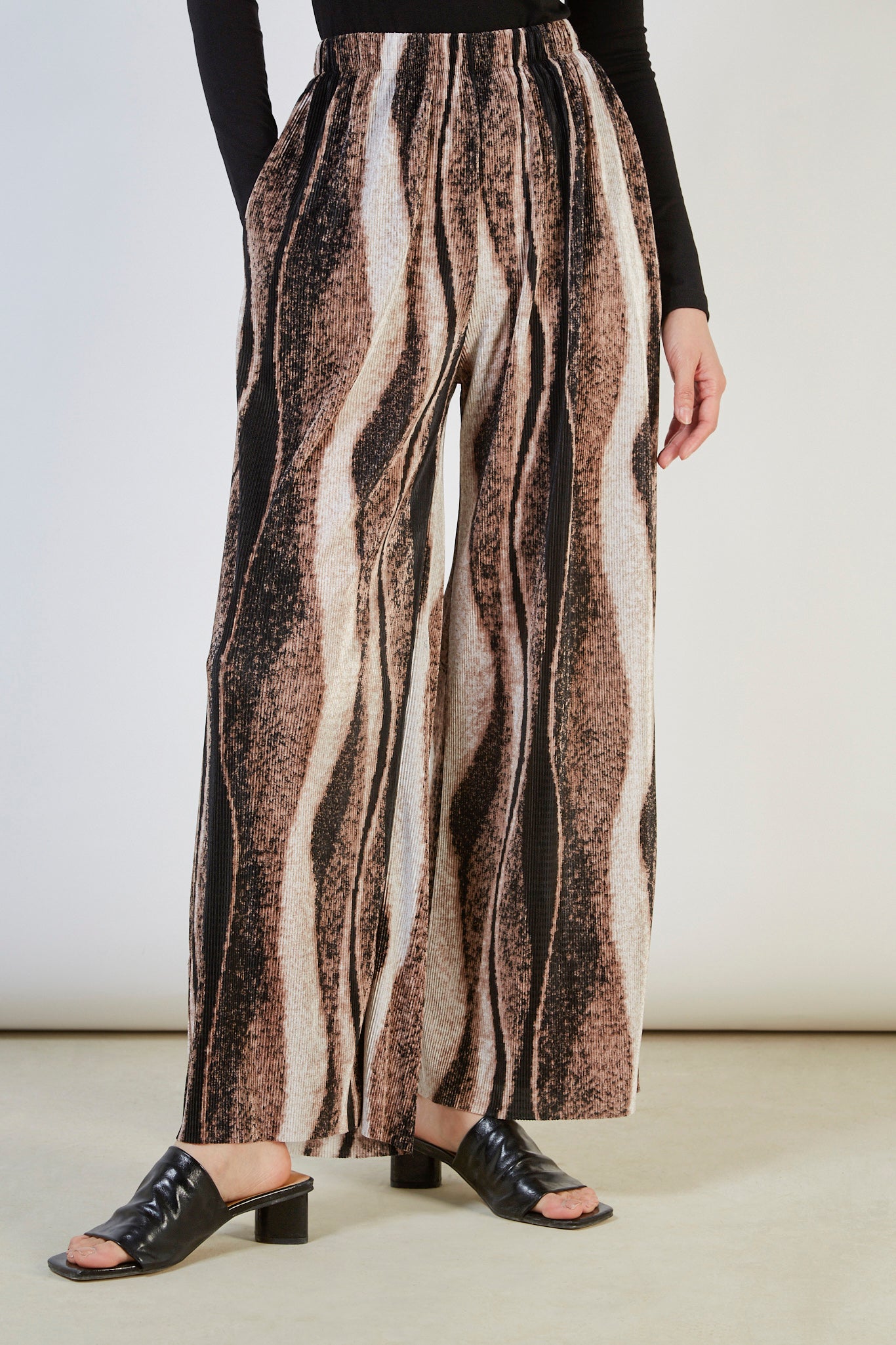 Beige and black abstract print trousers