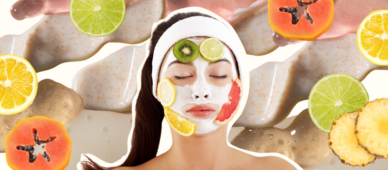 A woman with clay mask on with slides of kiwi, lime, lemon and orange around her face