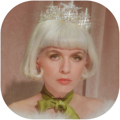 vintage woman with green tie and crown on her head.