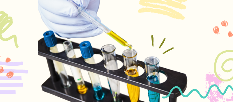 Chemicals in six different test tubes on a rack with cartoon graphics