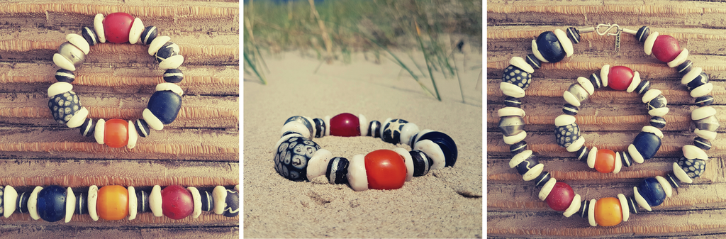 Handcrafted necklace and bracelet with white shells from Indonesia, rare honey-colored Berber amber beads, ebony beads with metal inlays from the Tuareg, old red and blue glass beads from Ethiopia and glass beads from the island of Java