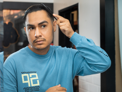 Model combing Suavecito Firme Hold Styling Gel through his hair