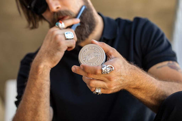 Suavecito Model combing beard with Suavecito beard product.