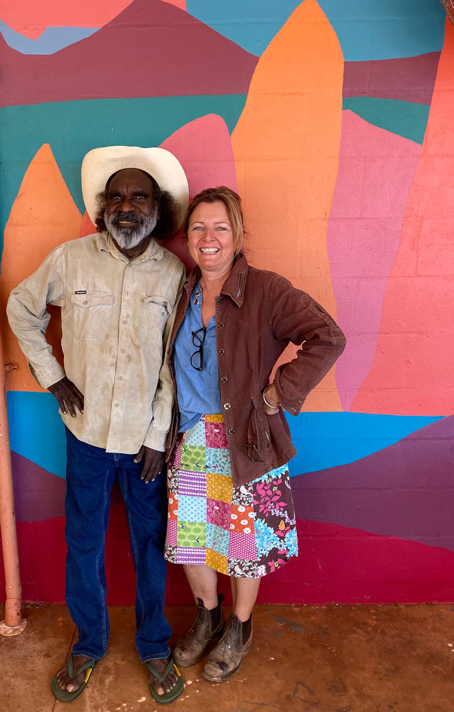 Meagan with indigenous man in front of painting