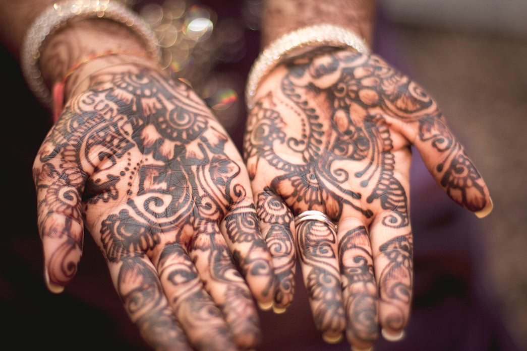 Hands, palms up, covered with Henna Tattoos