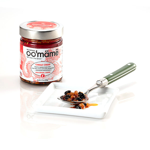 jar of oomame chile crisp with spoon on white saucer