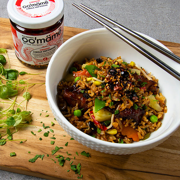 White bowl with chopsticks and fried rice with vegetables and oo’mämē. Jar of Chinese oo’mämē.