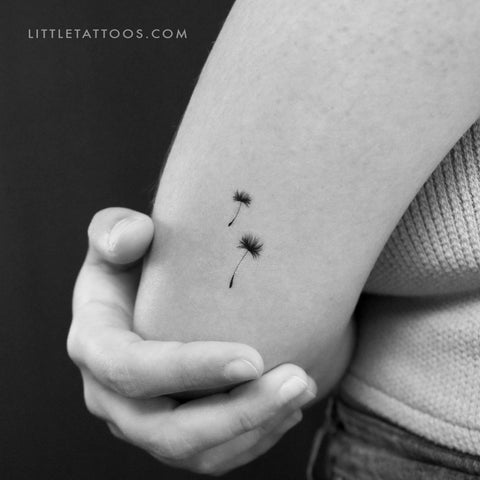 Minimalistic style dandelion seed tattoo placed on the