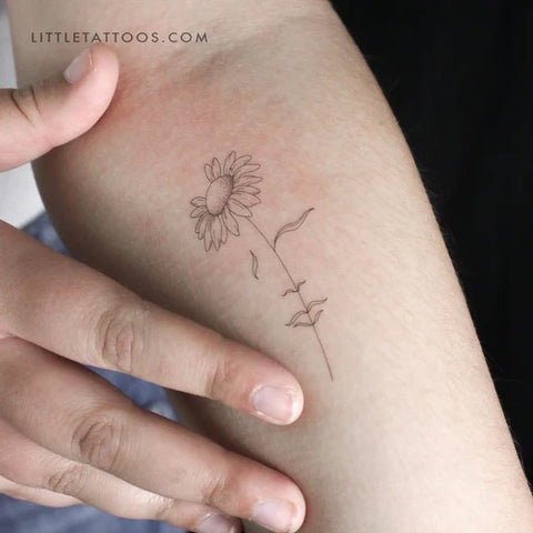 Female figure tattoos: Woman's face daisy tattoo