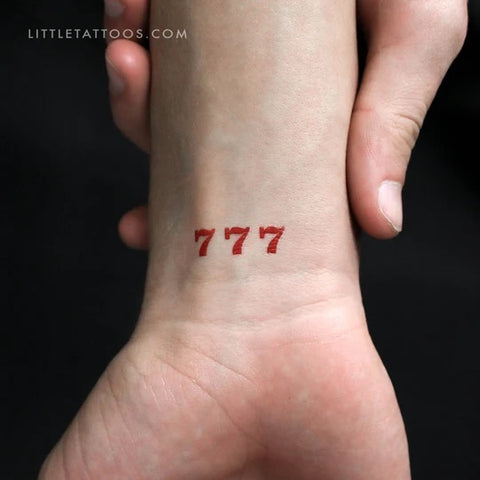 Red tattoos: 777 angel number tattoo