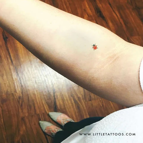 Red tattoos: Red ladybug tattoo