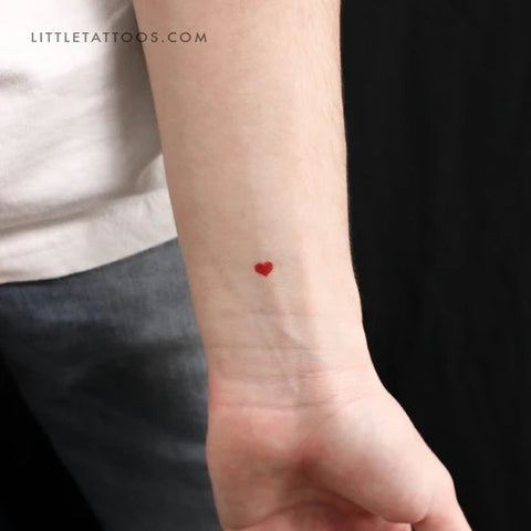 Red tattoos: Tiny red heart tattoo