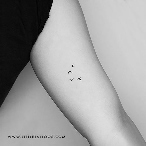 Fine line style flying birds tattoo located on the