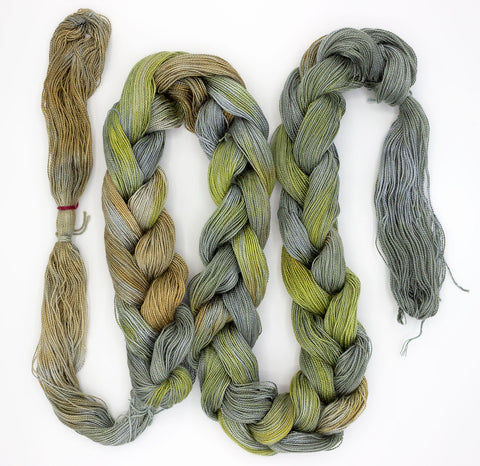 Liam paints 5/2 Tencel yarn - an earthy colored warp