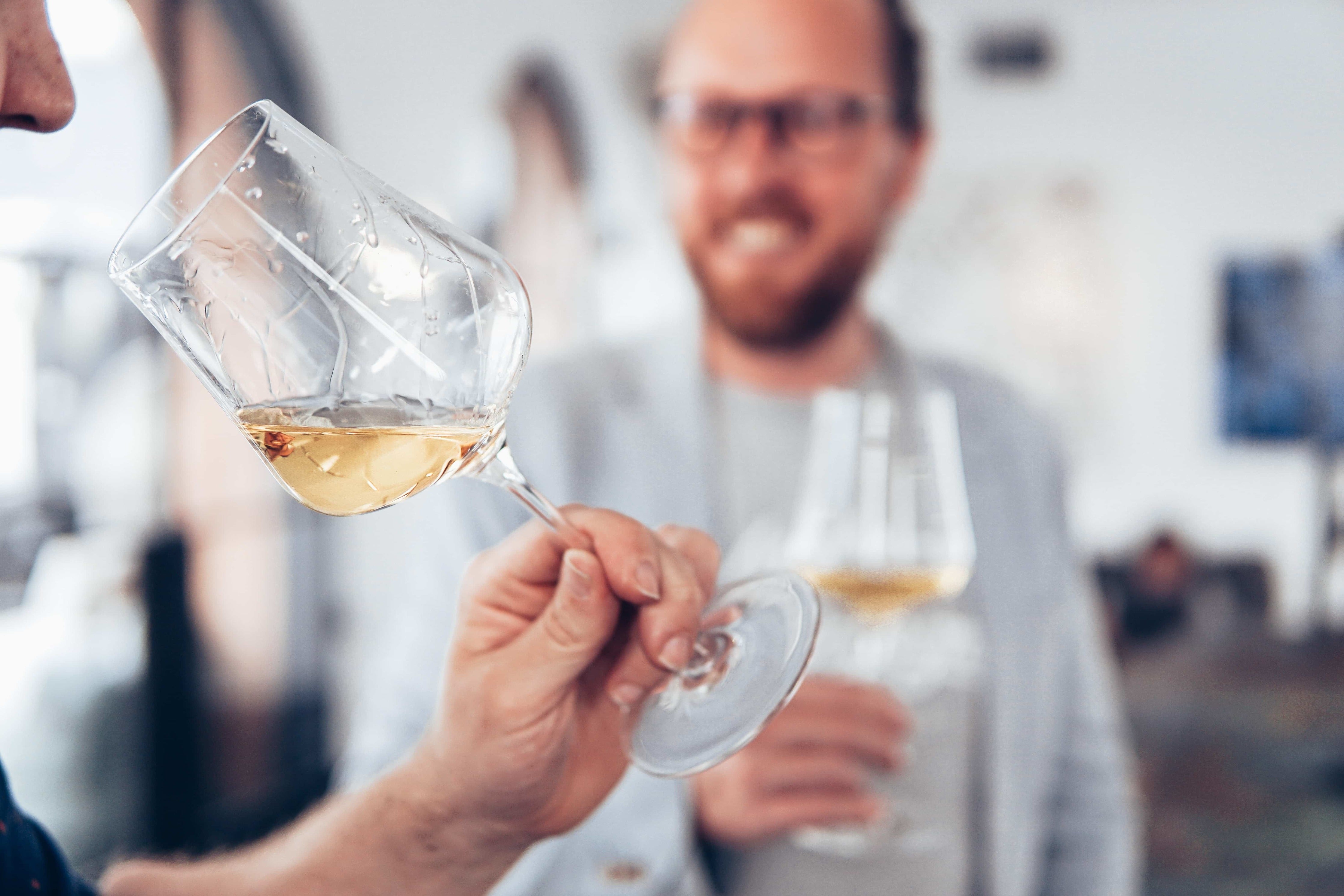 Man Drinking White Wine at Wine Tasting