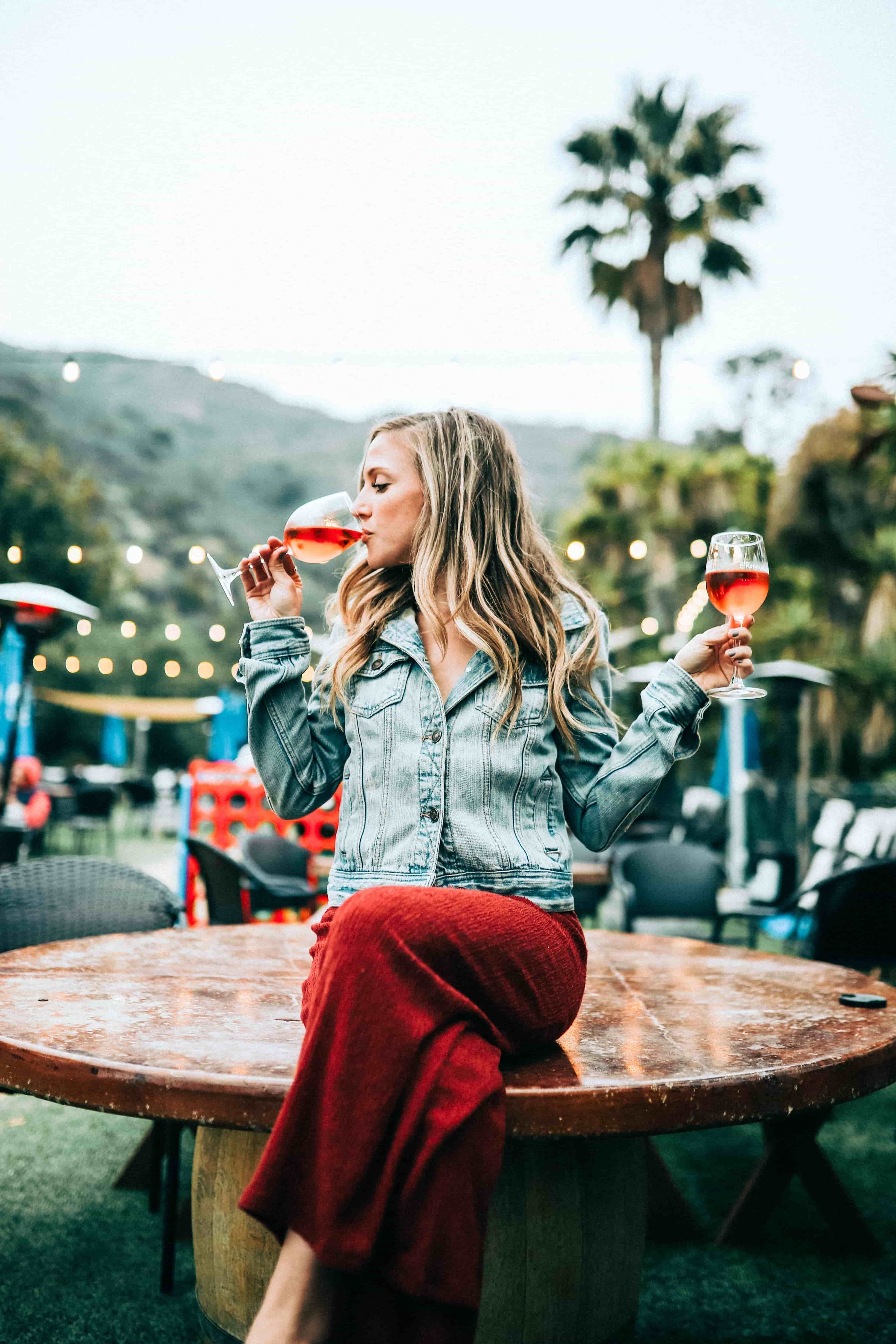 Woman Drinking Red Wine at Wine Tasting Dressed Up