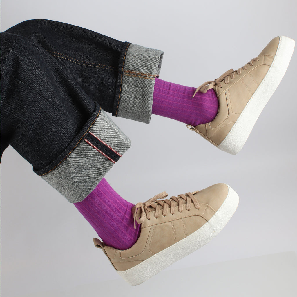 man wearing purple wool ribbed socks and trainers