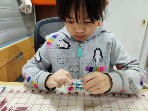 Lil lady hand stitching a test scrunchie