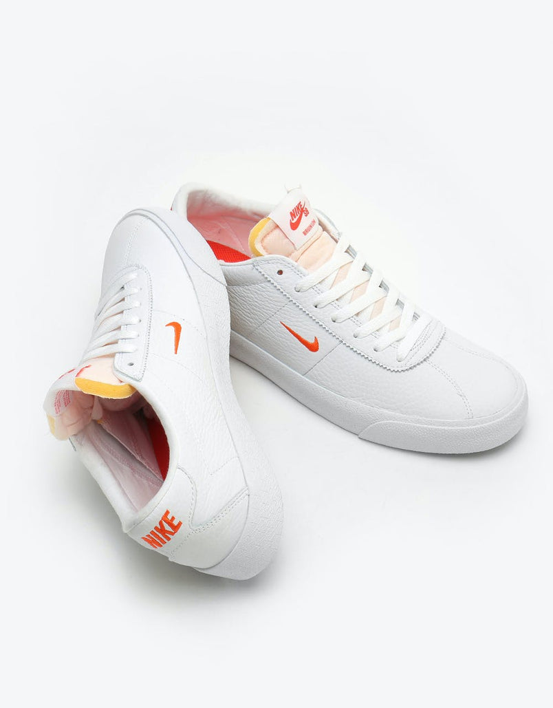 orange and white nikes