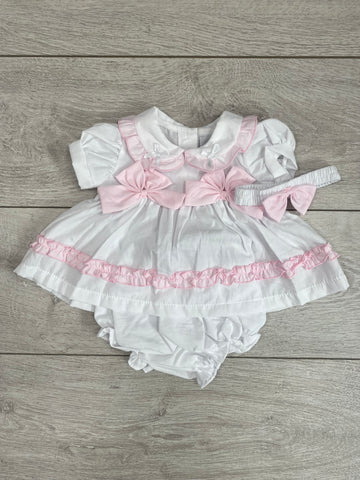 This gorgeous little white dress would make a stunning outfit this summer. Featuring a cute pink embroidered trim and matching pink bows. This short and dress set also comes with a matching headband.