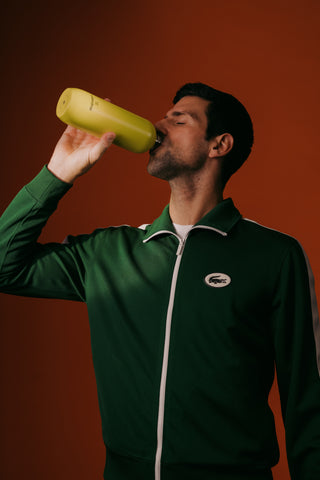 Novak Djokovic drinking out of a waterdrop® bottle