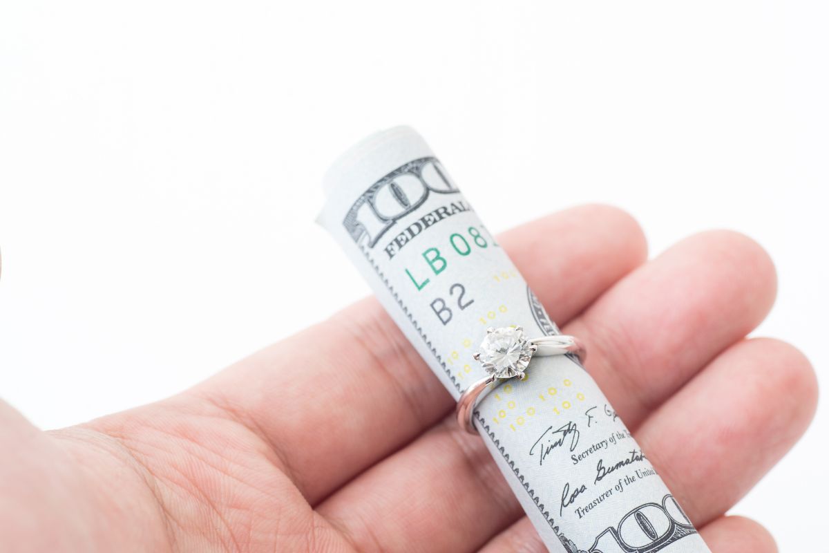 A bundle of money inside the man made diamond ring showing its monetary value