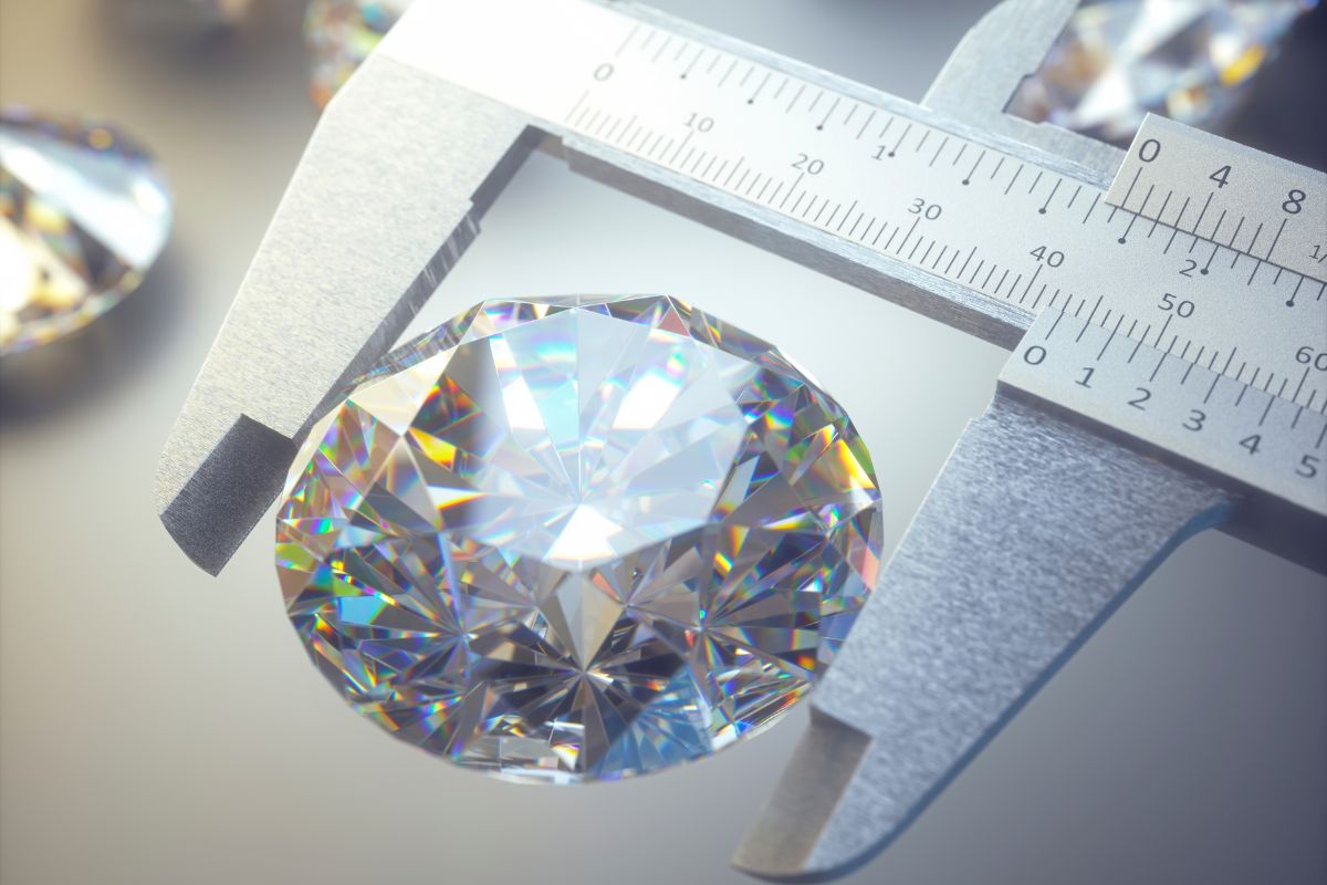 A diamond expert measuring the size of diamond with the help of a caliper.