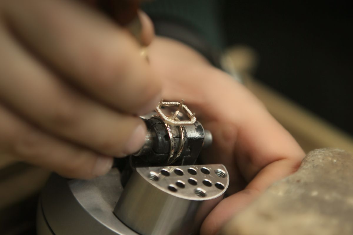 A diamond expert working on diamond four prong Solitaire setting.