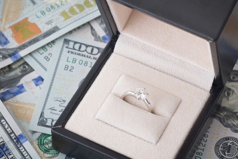 A diamond ring with a lot of dollars around it