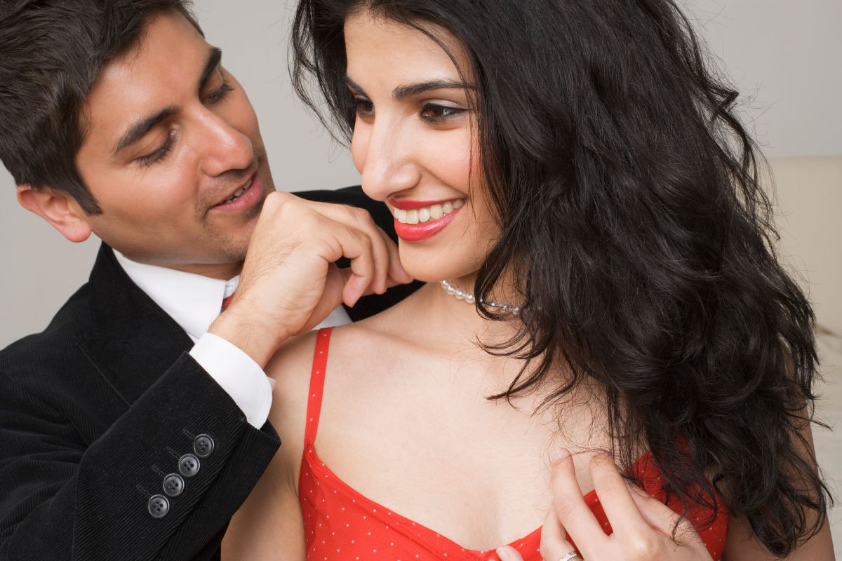 A guy Fastening necklace for his girlfriend