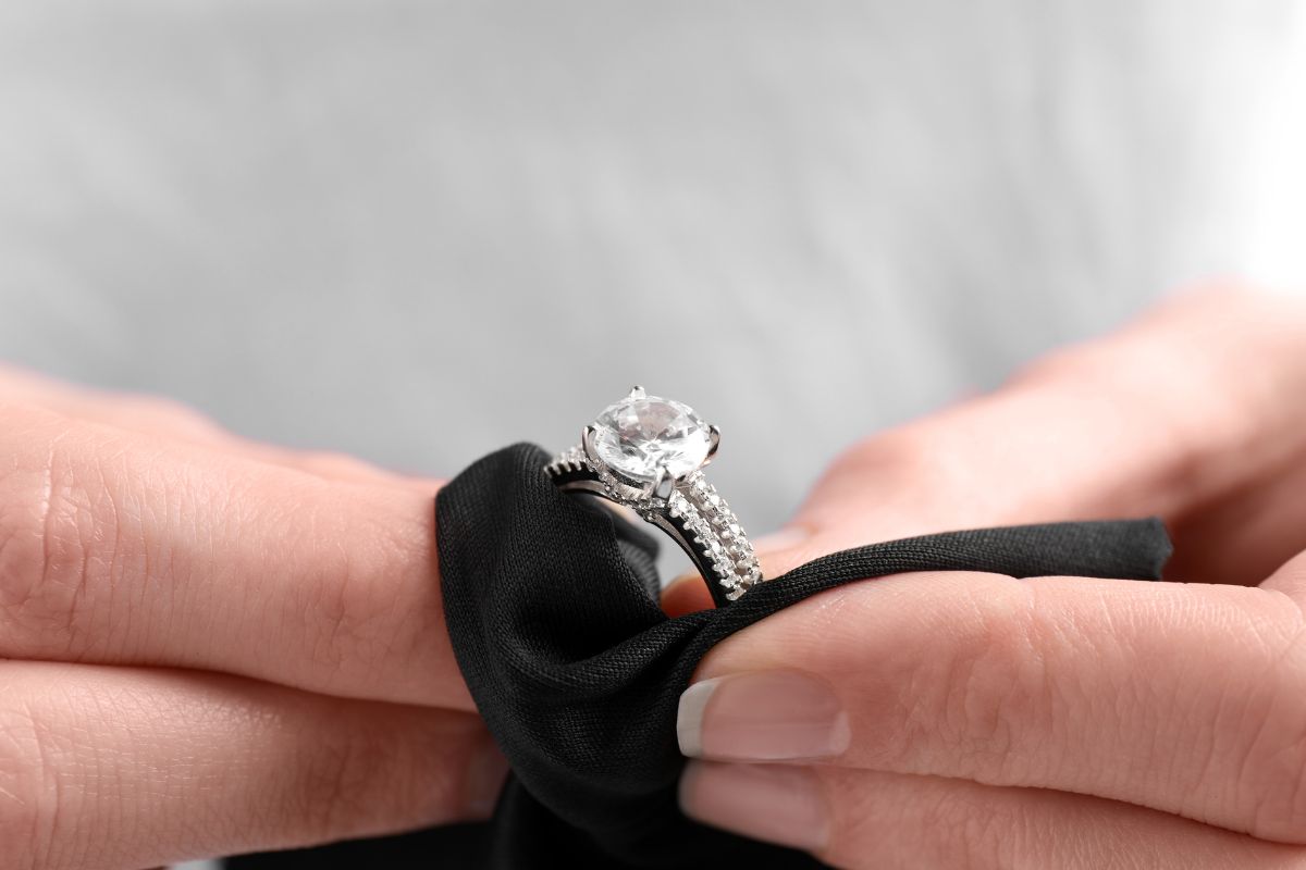 A guy cleaning a diamond ring